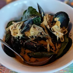 Melee pineapple curry mussels.  Lemongrass coconut basil aromatic ground pork, Thai chili and lime leaf.
