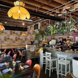 a dining area with tables and chairs
