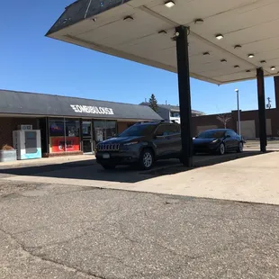 a car parked in front of a gas station