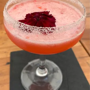 a close up of a drink in a coupe glass