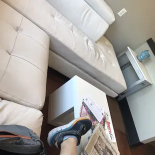 Kicking back on the white leather sofa