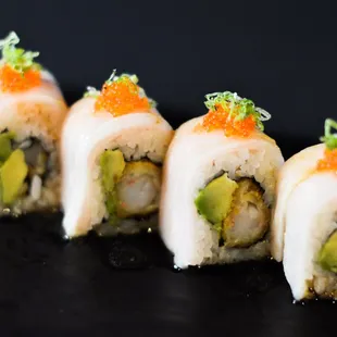 Tango: Shrimp tempura, avocado, yellowtail, orange tobiko, green onion, meyer lemon sauce, eel sauce