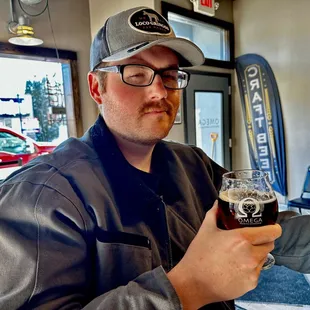 a man holding a glass of beer