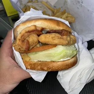 Two juicy thick tenders with thick bacon and a really big hand