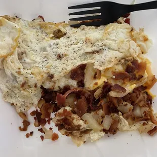 Egg white bacon and cheese omelette with grilled onions. This isn't an omelette. And I found a couple green peppers in here