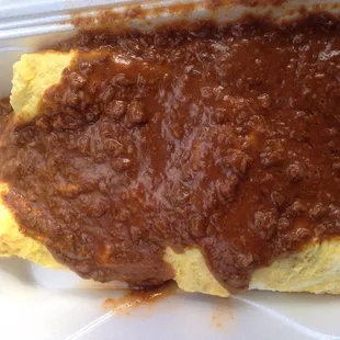 Mexican omelette filled with veggies and ground beef, cheese. Top with chili