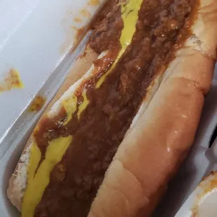 a hot dog with chili and mustard