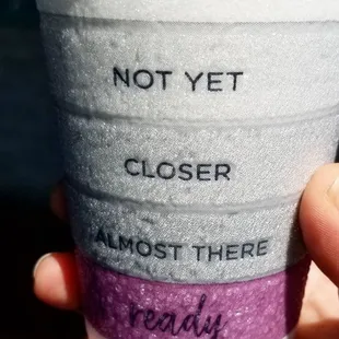 a hand holding a cup of coffee