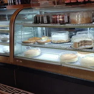  display case filled with cakes and pastries