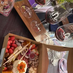 a box of fruit and a glass of wine