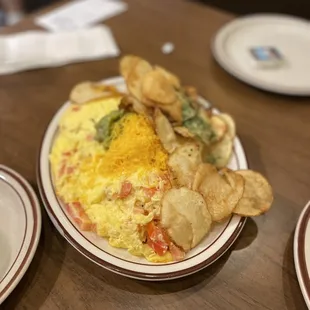 an omelet and chips on a plate