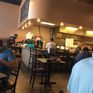 people sitting at tables in a restaurant