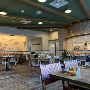 a dining area with tables and chairs