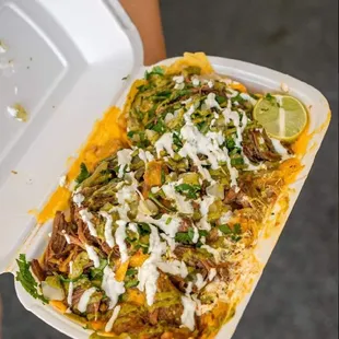 a person holding a container of food