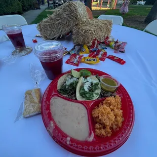 Carne asada plate with rice, beans, a lemon bar and Jamaica to drink
