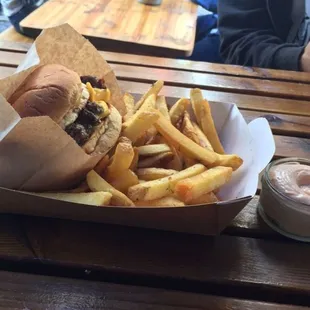 a basket of fries and a bottle of ketchup