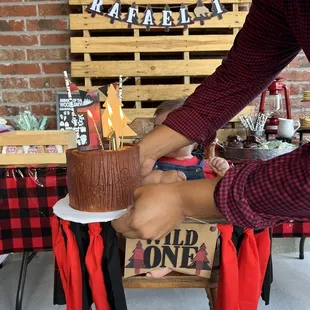 a man cutting a cake