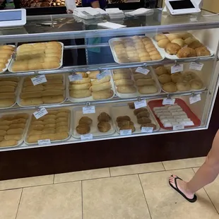 a woman standing in front of a bakery