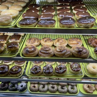 a variety of donuts in a display case