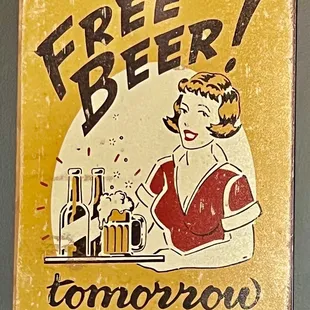 a woman sitting at a table with a bottle of beer