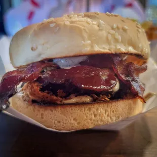 Bleu on Black Burger  Blackened seasoning on a smash patty with blue cheese and bacon, grilled onions and roasted garlic, peppercorn sauce.