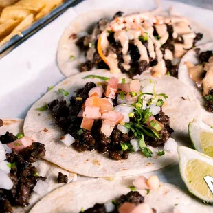 a variety of tacos on a plate