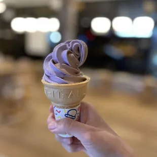 a hand holding an ice cream cone