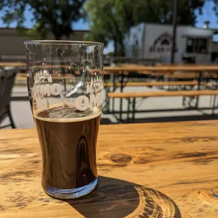 a pint of beer on a wooden table
