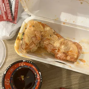 a chicken in a styrofoam container