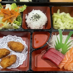 Bento box with fried oysters and sashimi
