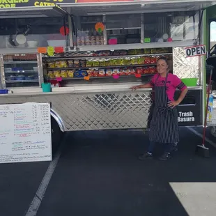 a woman standing in front of a food truck