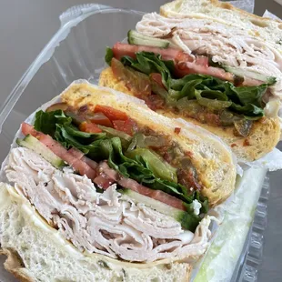 a turkey sandwich in a plastic container