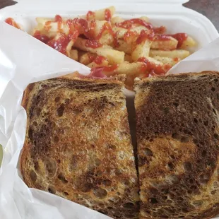 Reuben sandwich and fries with salt, pepper and ketchup added.