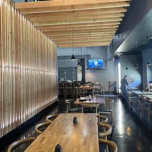 a restaurant with wooden tables and chairs