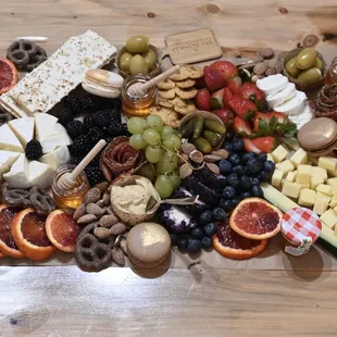 a variety of cheeses, meats, fruits, and nuts