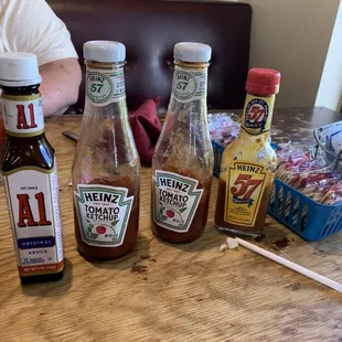 Sticky bottles of ketchup and steak sauce.