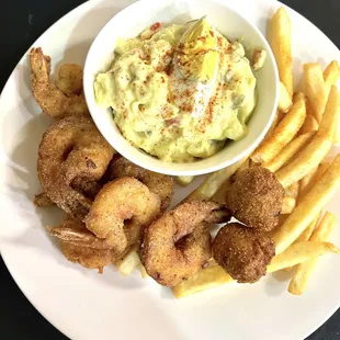 Fried shrimp with potato salad, fries, and hush puppies