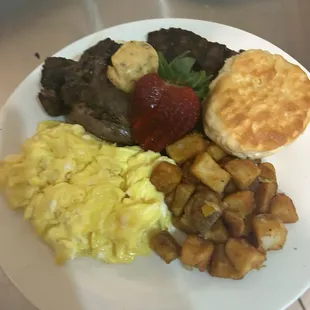 On Point steak and eggs, with smothered potatoes, and biscuit