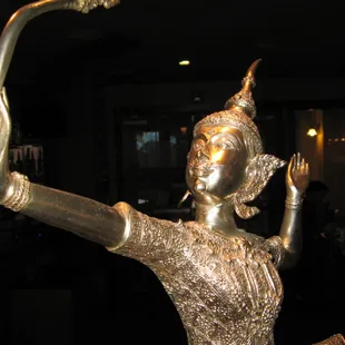 a statue of a woman holding a stick