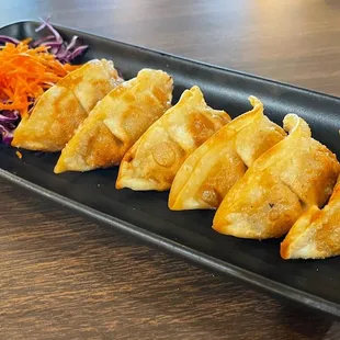  a plate of fried dumplings
