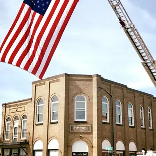 a firetruck and a flag in front of a building
