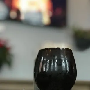 a glass of wine sitting on a table