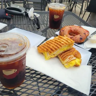 2 iced americano mediums, triple berry bagel with butter, breakfast croissant sandwich with turkey and cheese on the side