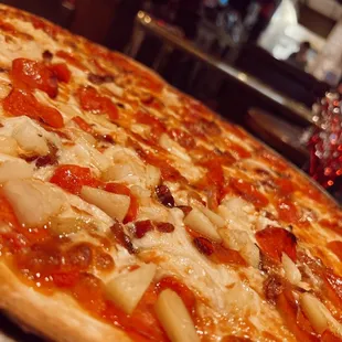 a pizza with onions and pepperoni