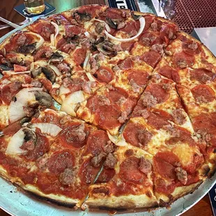 Sausage and pepperoni pizza with mushrooms and onions on half