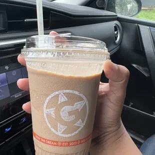 a hand holding a cup of coffee