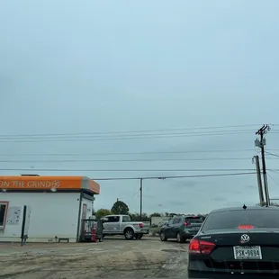 cars parked in front of a coffee shop
