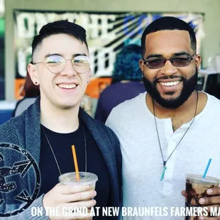 two men holding drinks