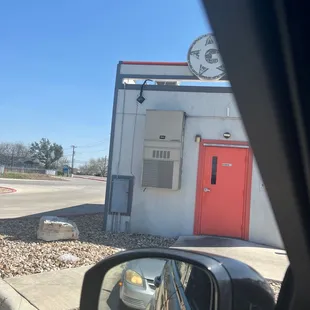 a red door and a white building