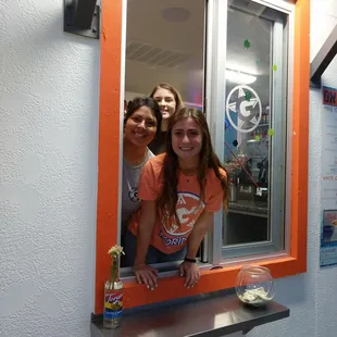 two girls looking out of a window
